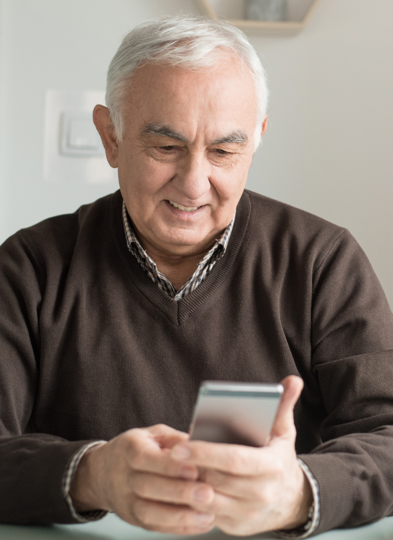 Image of an elderly man on a cell phone for contact us on Facebook